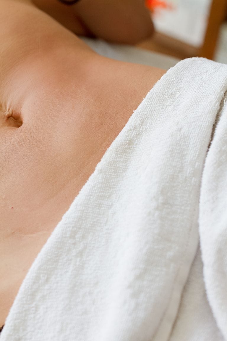 Close-up of a person relaxing with a towel during a spa treatment, highlighting skin and relaxation.
